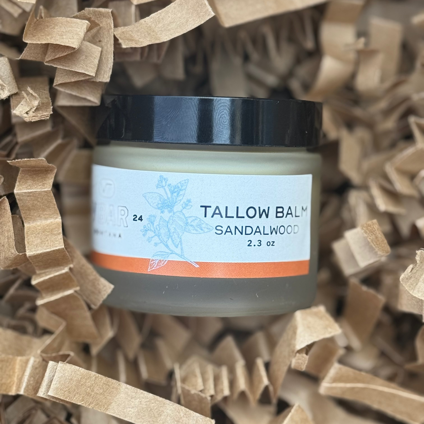 jar of Vbar Montana sandalwood tallow balm on a brown background