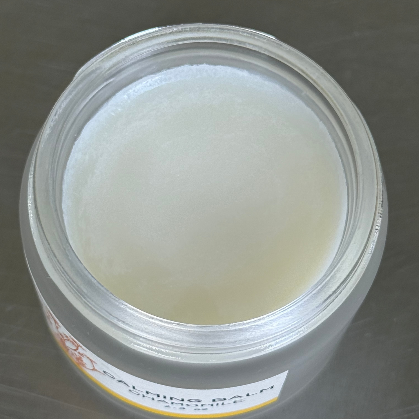 Vbar Montana calming chamomile tallow balm, showing the product inside of the jar