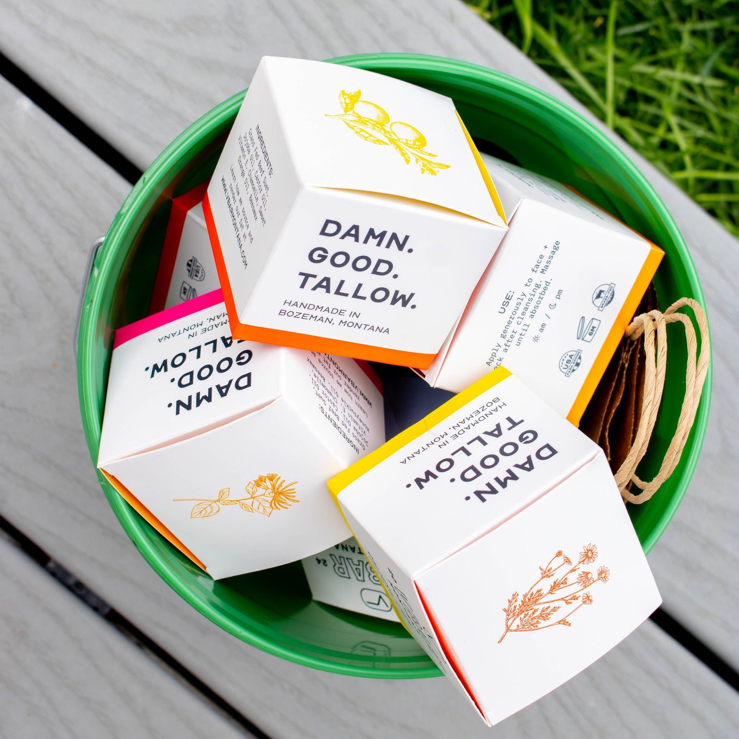 boxes of VBar Montana tallow balms in a green bucket