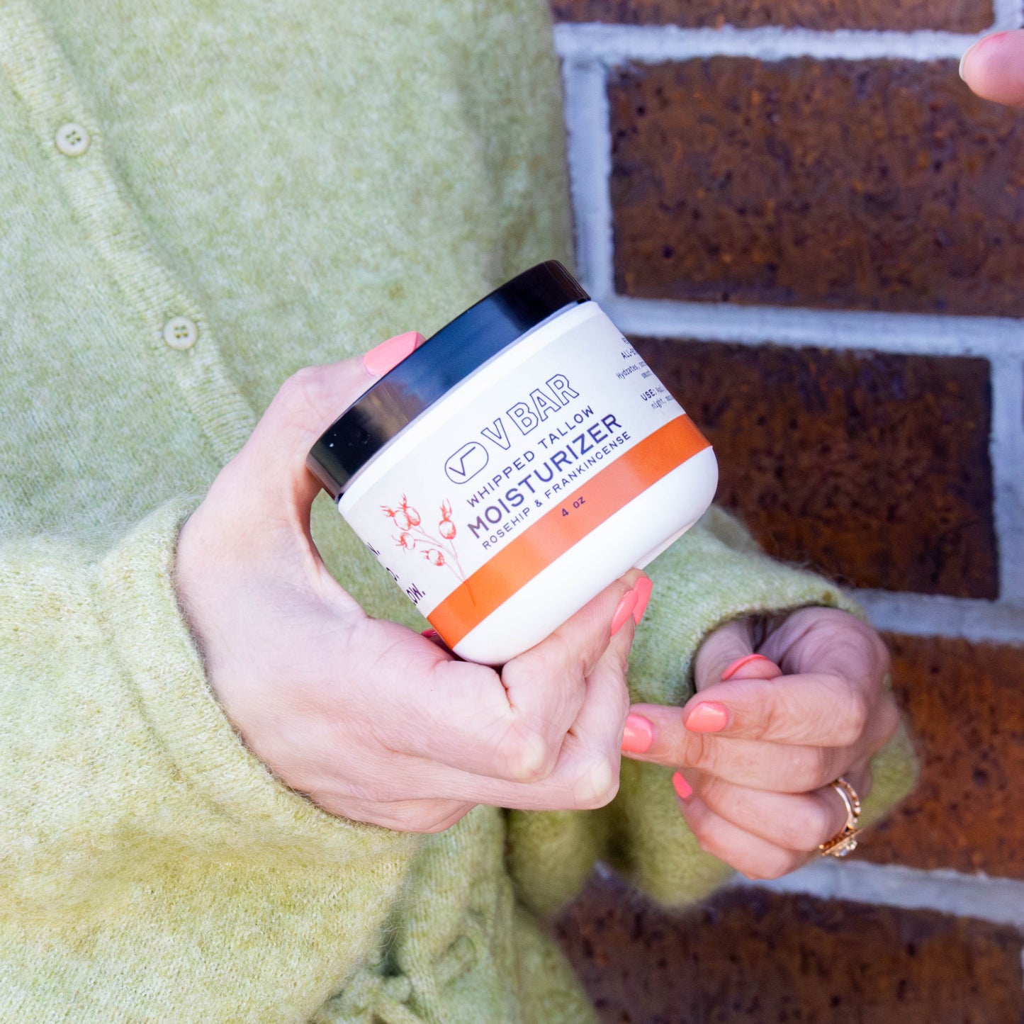 Whipped tallow moisturizer made from grass-fed beef suet sourced from Montana ranches in a woman's hand
