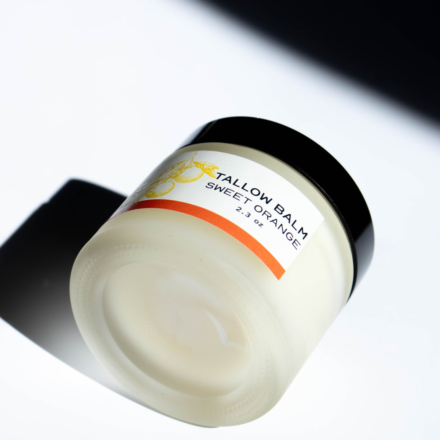 jar of Vbar Montana sweet orange tallow balm, made from grass fed beef suet on a white background