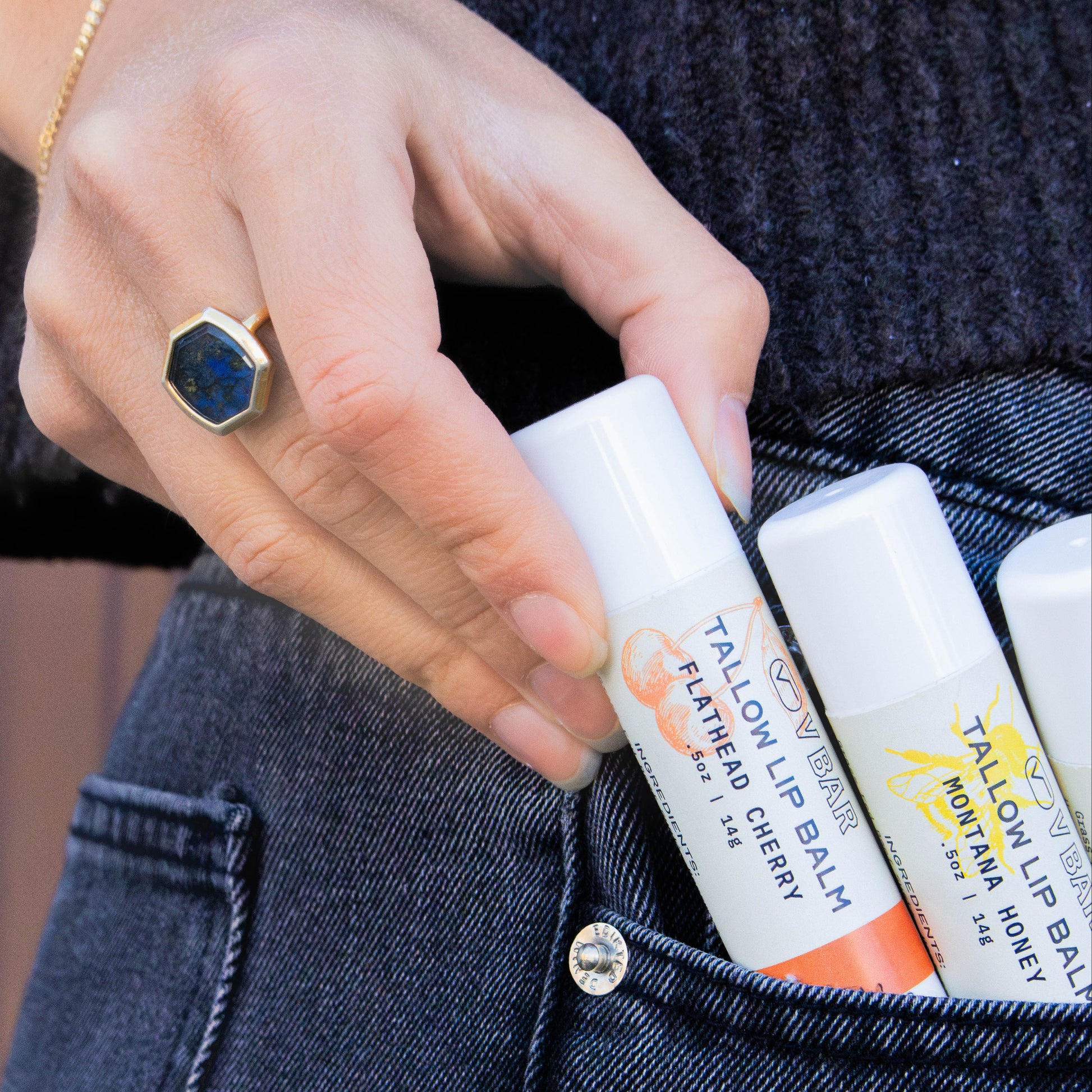 Natural tallow lip balm made from grass-fed beef suet for dry lips and sourced from Montana ranches being pulled out of a jean pocket